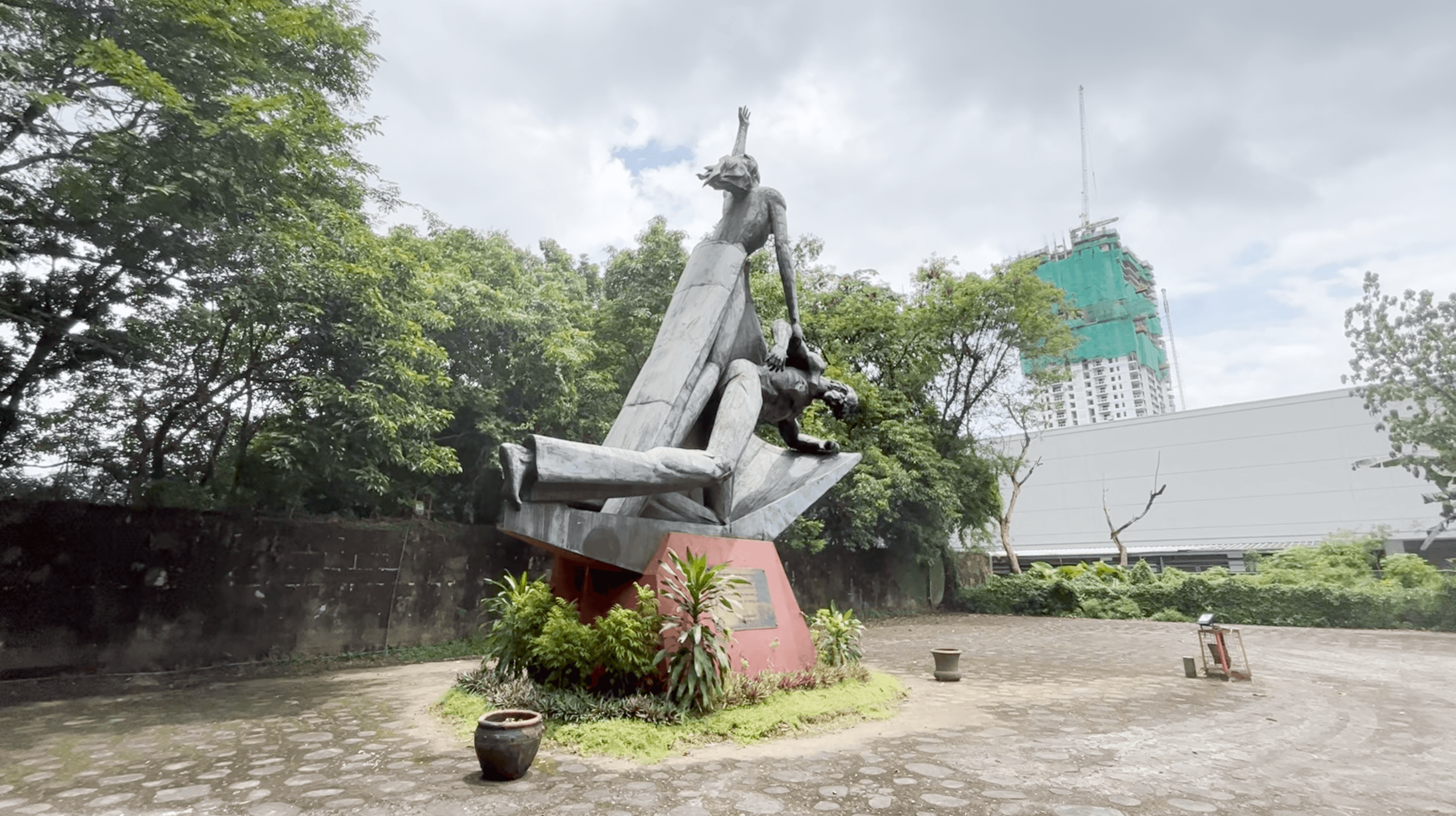 Depiction of the Philippine mother land, while the man represents self-sacrifice & heroism, alluding to the martyrs who gave their life for the freedom of the Philippine people during martial law.